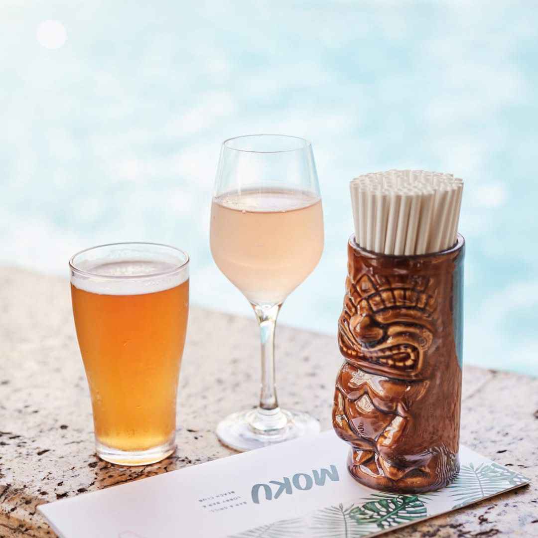 Glass of wine & beer next to pool